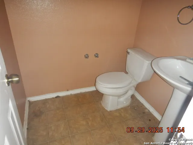 a white toilet sitting next to a white sink