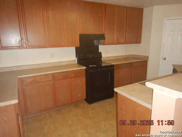 a kitchen with cabinets and appliances