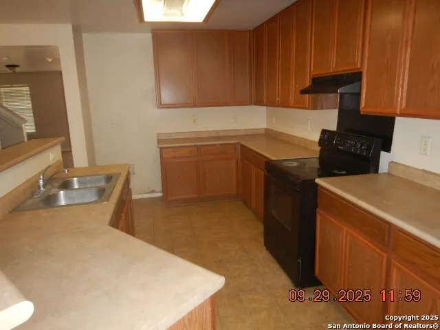 a kitchen with a sink stove and cabinets