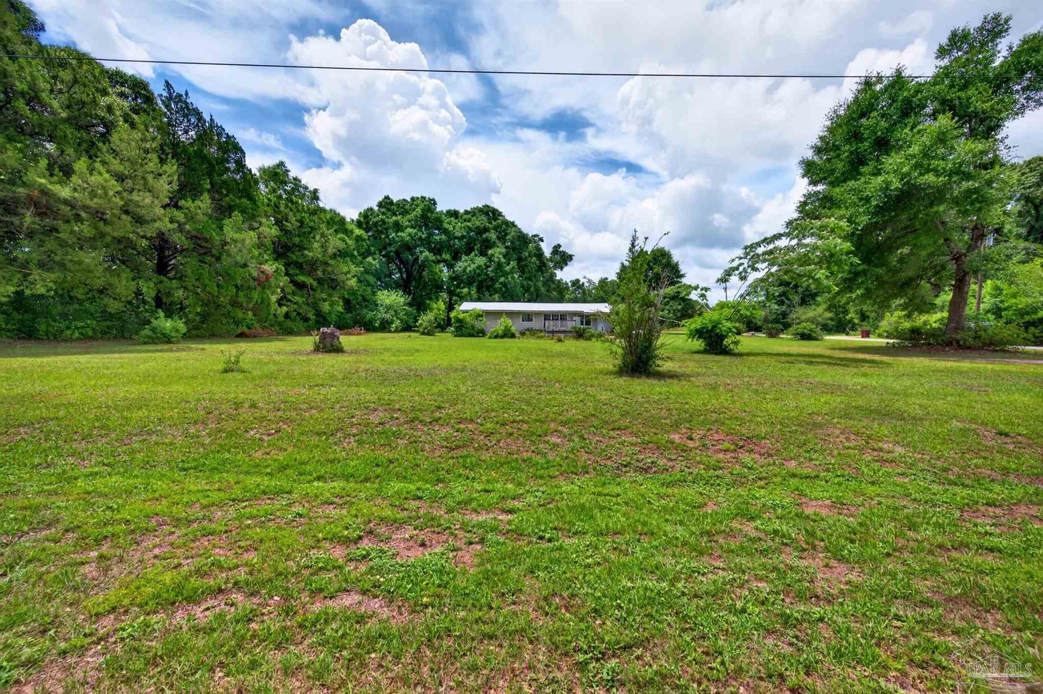 6253 Allentown Road Milton, FL 32570 - Photo 31 of 31 a view of a big yard with plants and large trees