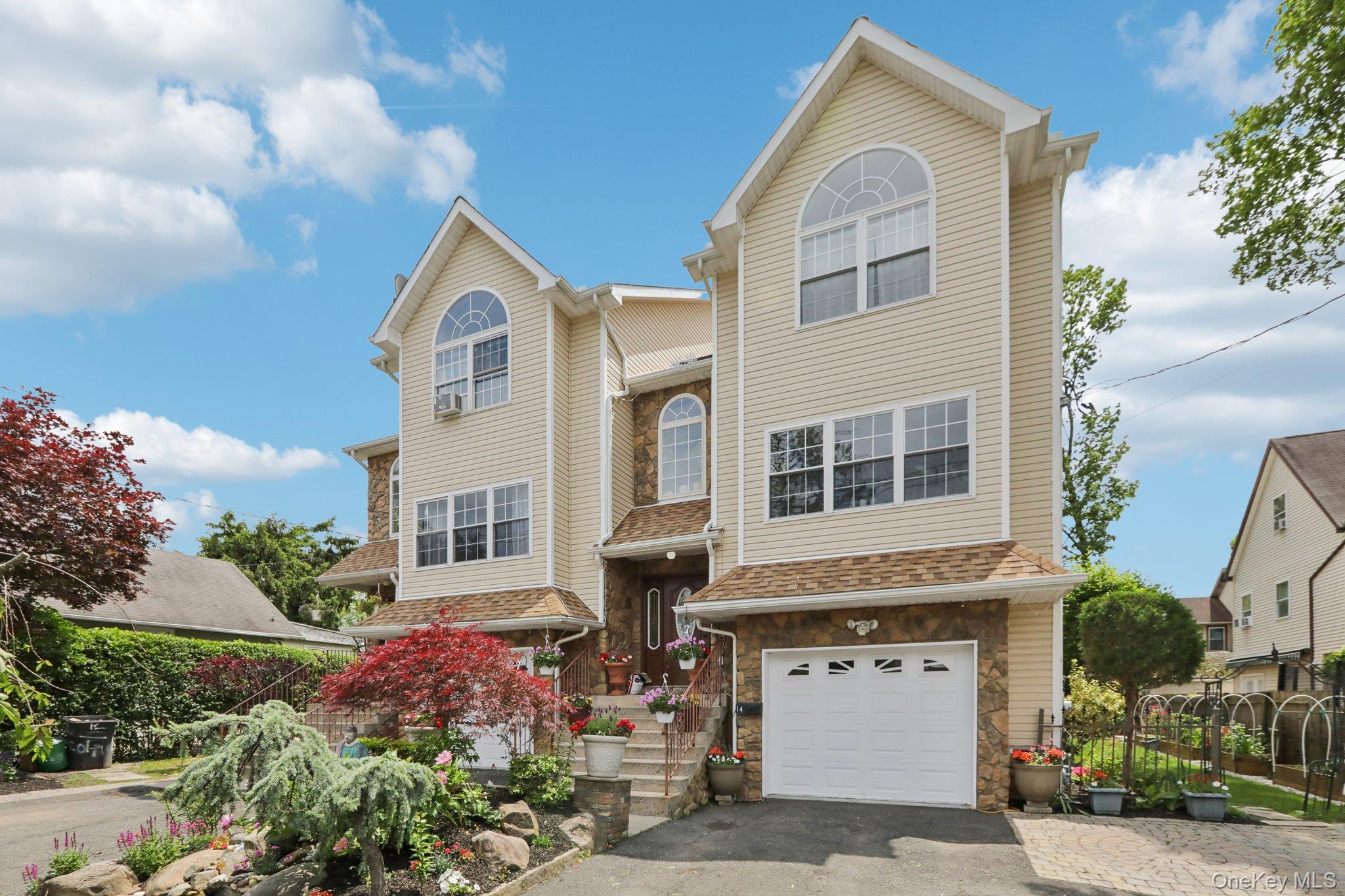 a front view of a house with a garden