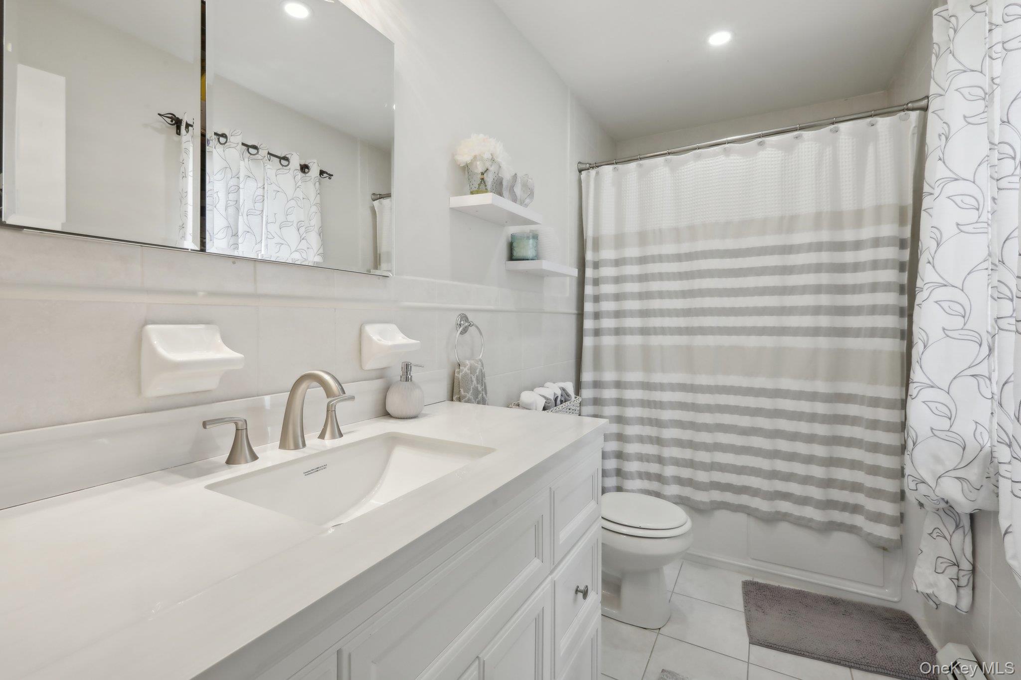 12-14 Lincoln Street Spring Valley, NY 10977 - Photo 14 of 39 a bathroom with a sink a toilet and shower