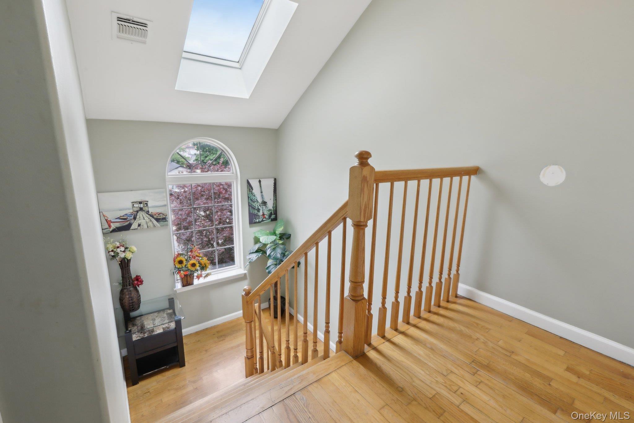 12-14 Lincoln Street Spring Valley, NY 10977 - Photo 18 of 33 Unit A, Level-3,Stairs, featuring a skylight, wood-type flooring, and lofted ceiling