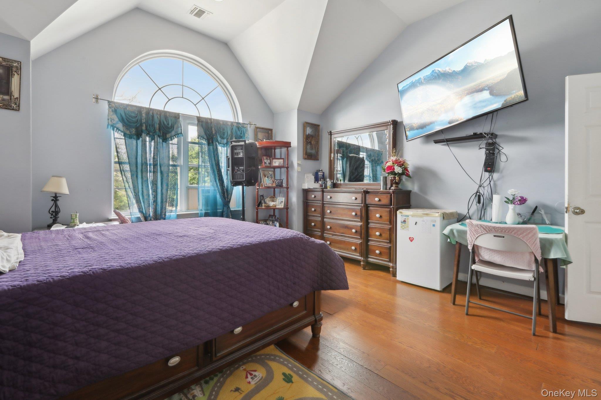 12-14 Lincoln Street Spring Valley, NY 10977 - Photo 20 of 39 a bedroom with a bed a dresser and book shelfs