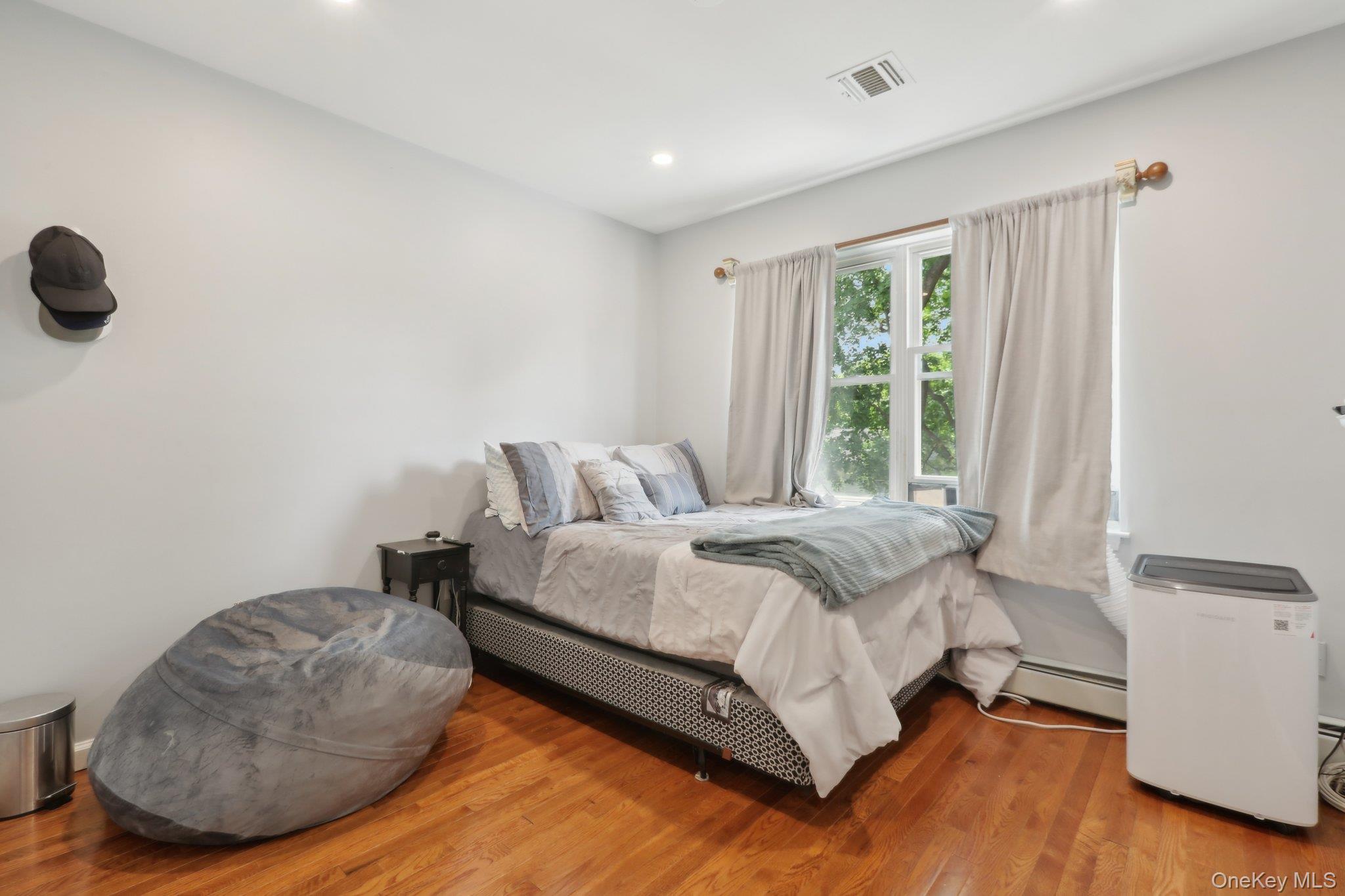 12-14 Lincoln Street Spring Valley, NY 10977 - Photo 23 of 39 Bedroom with recessed lighting, wood finished floors, and baseboard heating