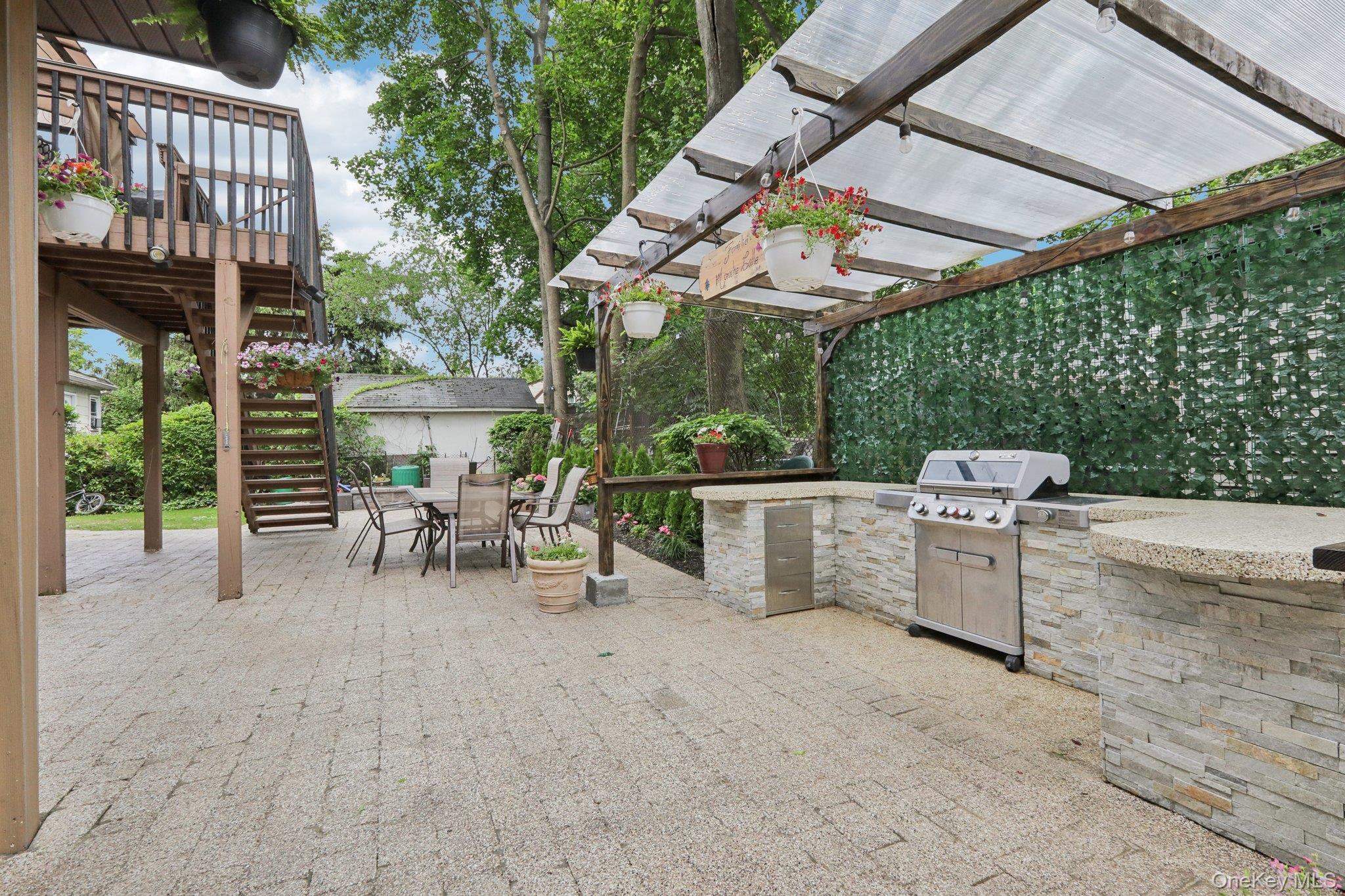 12-14 Lincoln Street Spring Valley, NY 10977 - Photo 24 of 33 View of patio featuring stairway, a pergola, and outdoor dining area