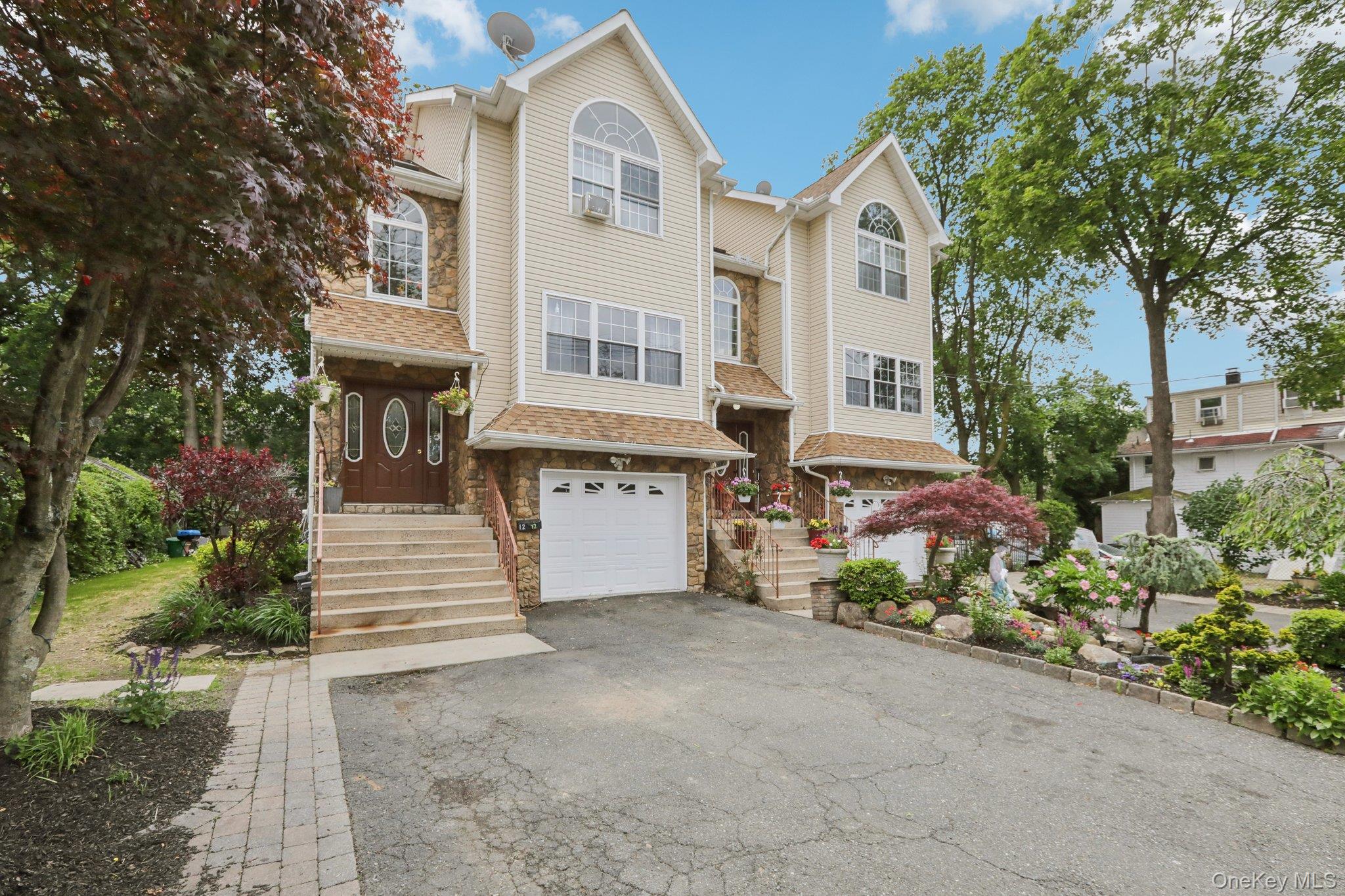 12-14 Lincoln Street Spring Valley, NY 10977 - Photo 28 of 39 a view of a white house with large windows and a small yard
