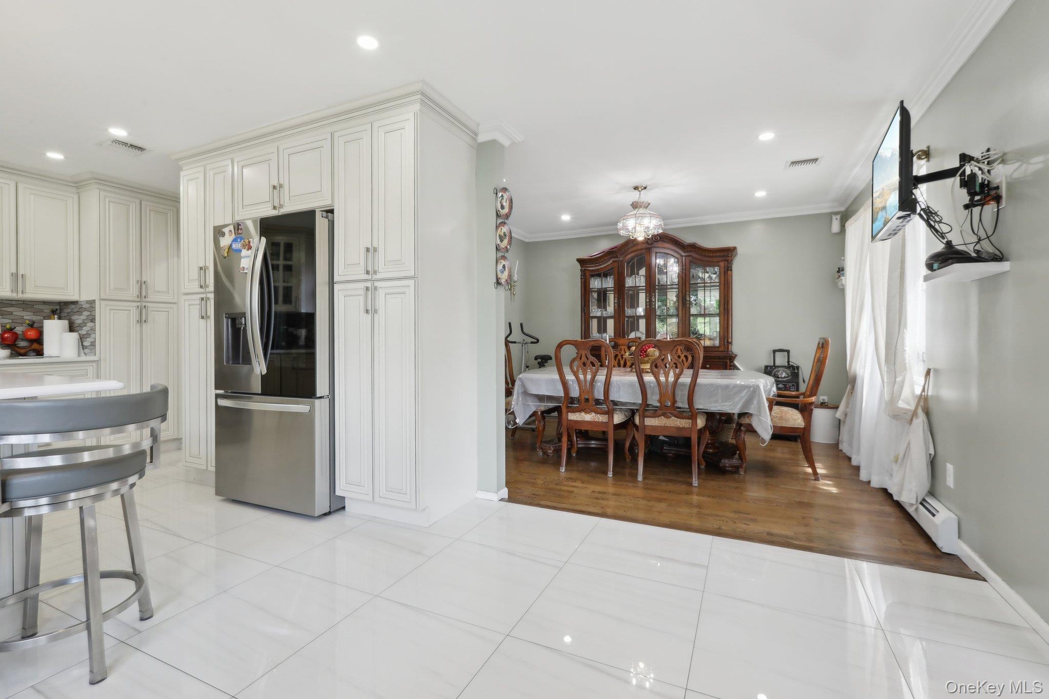 12-14 Lincoln Street Spring Valley, NY 10977 - Photo 7 of 39 a view of a kitchen with dining area refrigerator and chairs
