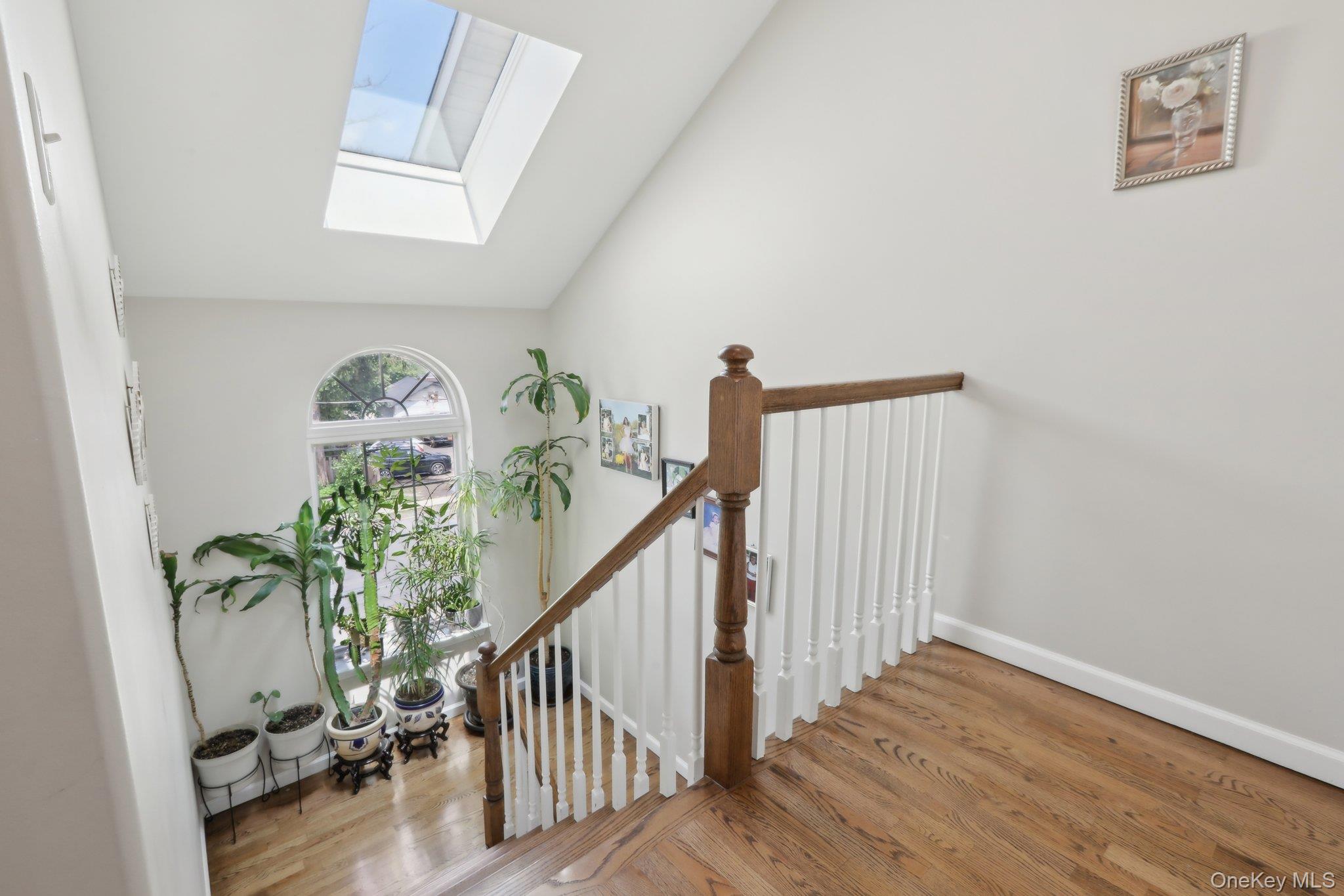 12-14 Lincoln Street Spring Valley, NY 10977 - Photo 8 of 33 Unit B, Level-3, Staircase featuring a skylight, wood finished floors, and vaulted ceiling