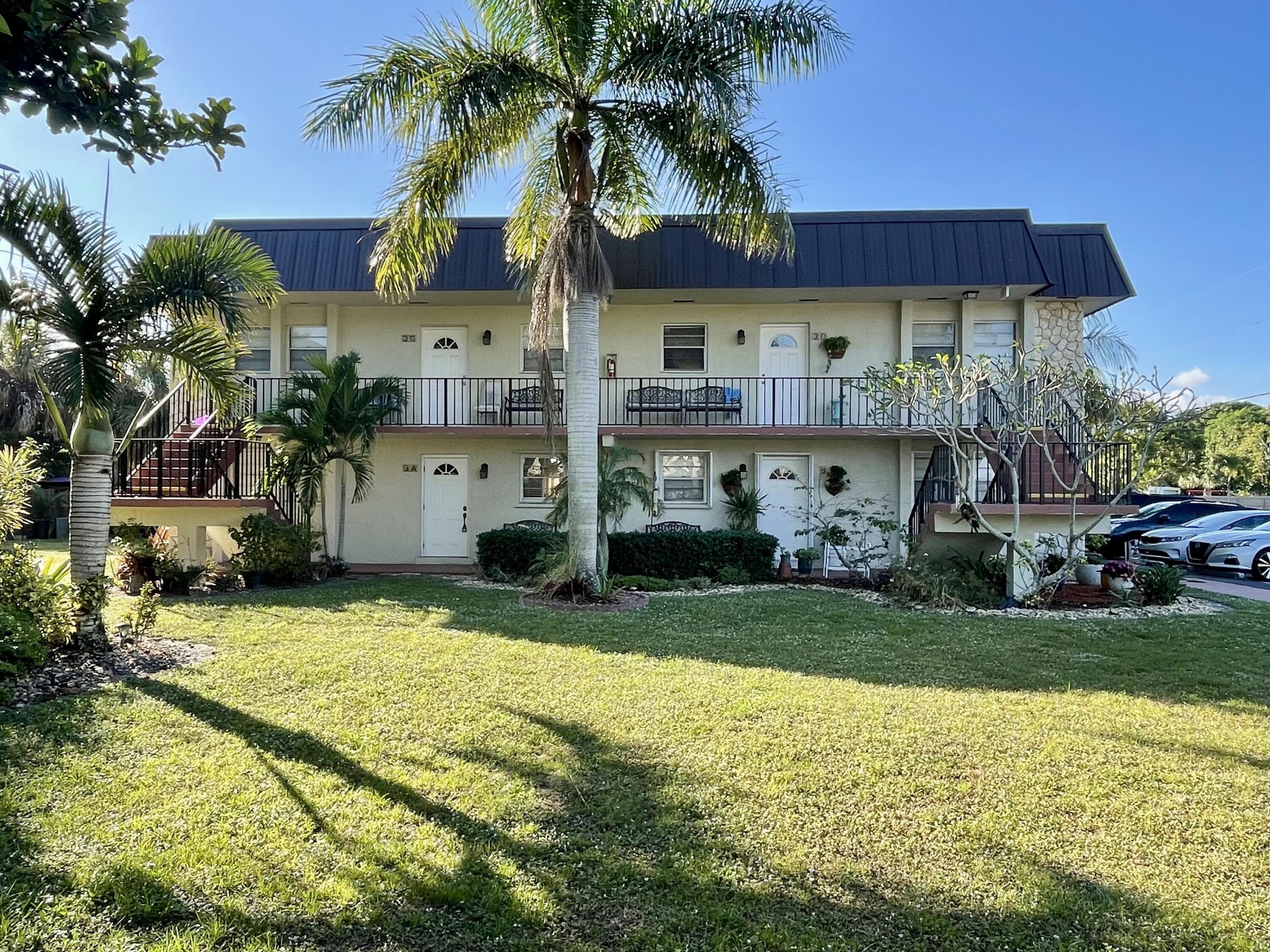 a view of house with yard and outdoor seating