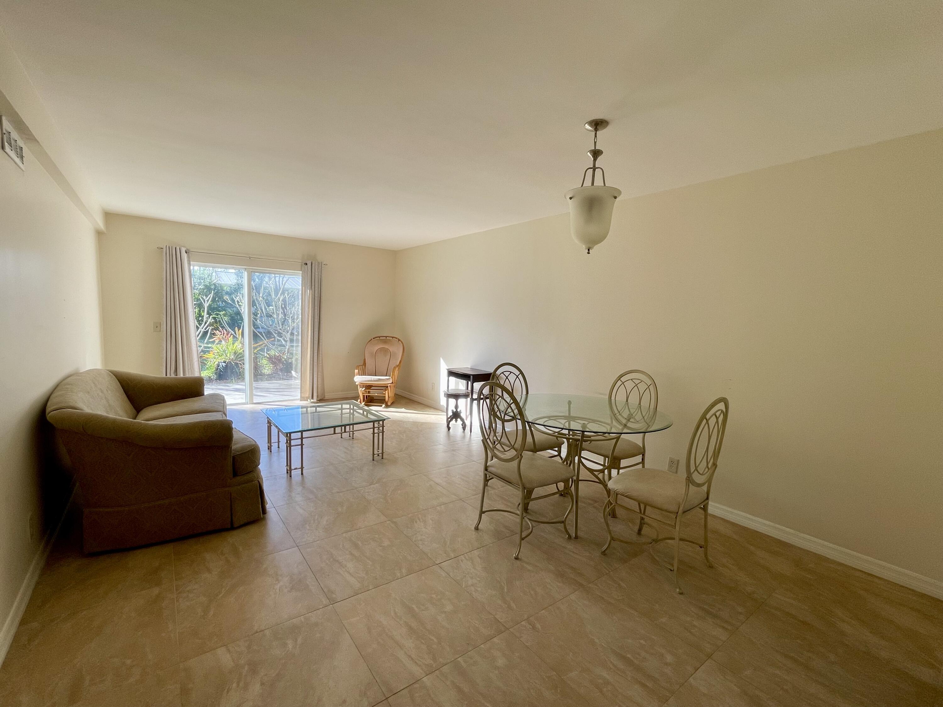 404 Fern Street, Unit 3A Jupiter, FL 33458 - Photo 4 of 12 a living room with furniture and a window