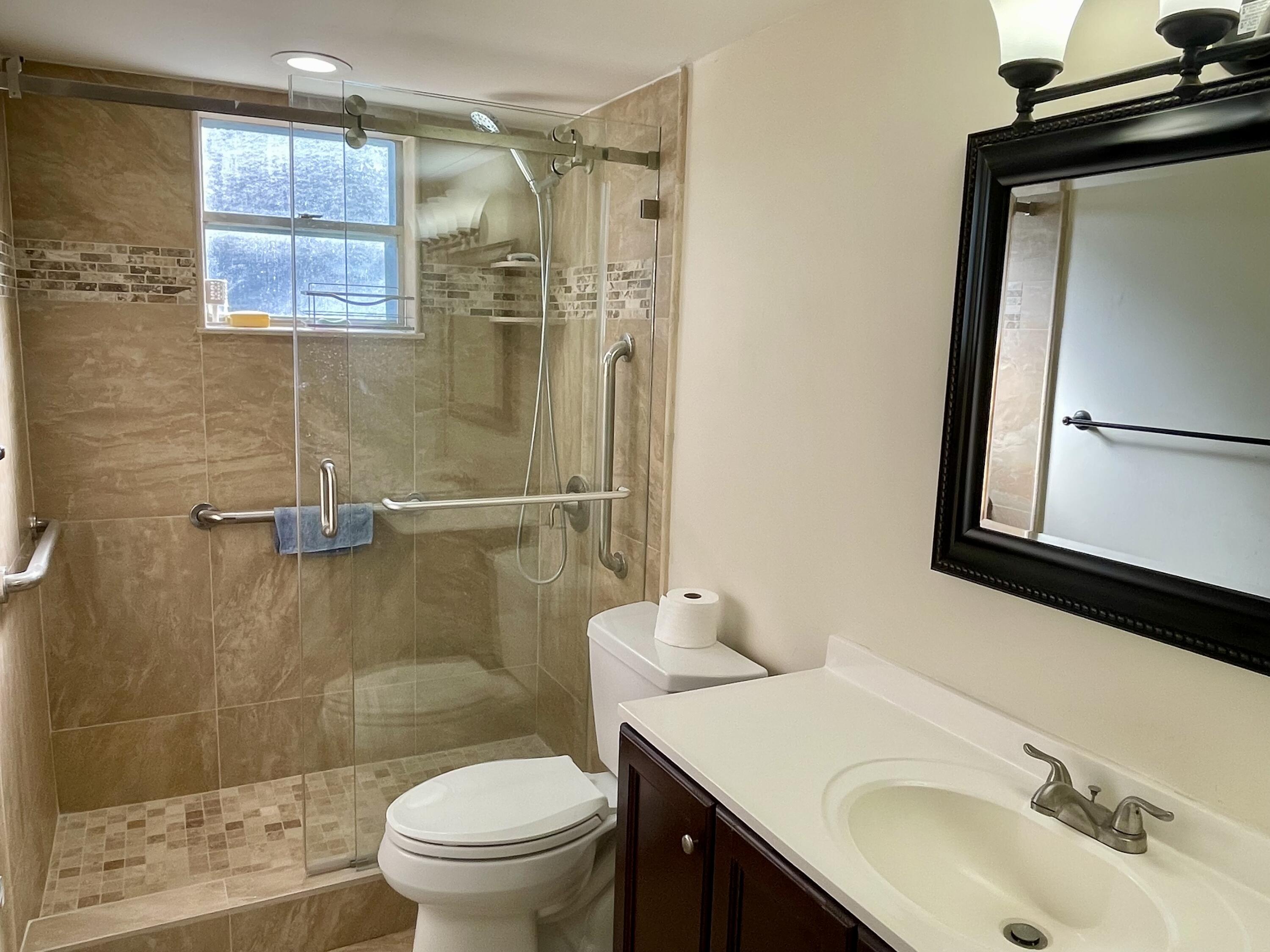 404 Fern Street, Unit 3A Jupiter, FL 33458 - Photo 5 of 12 a bathroom with a sink a toilet and shower