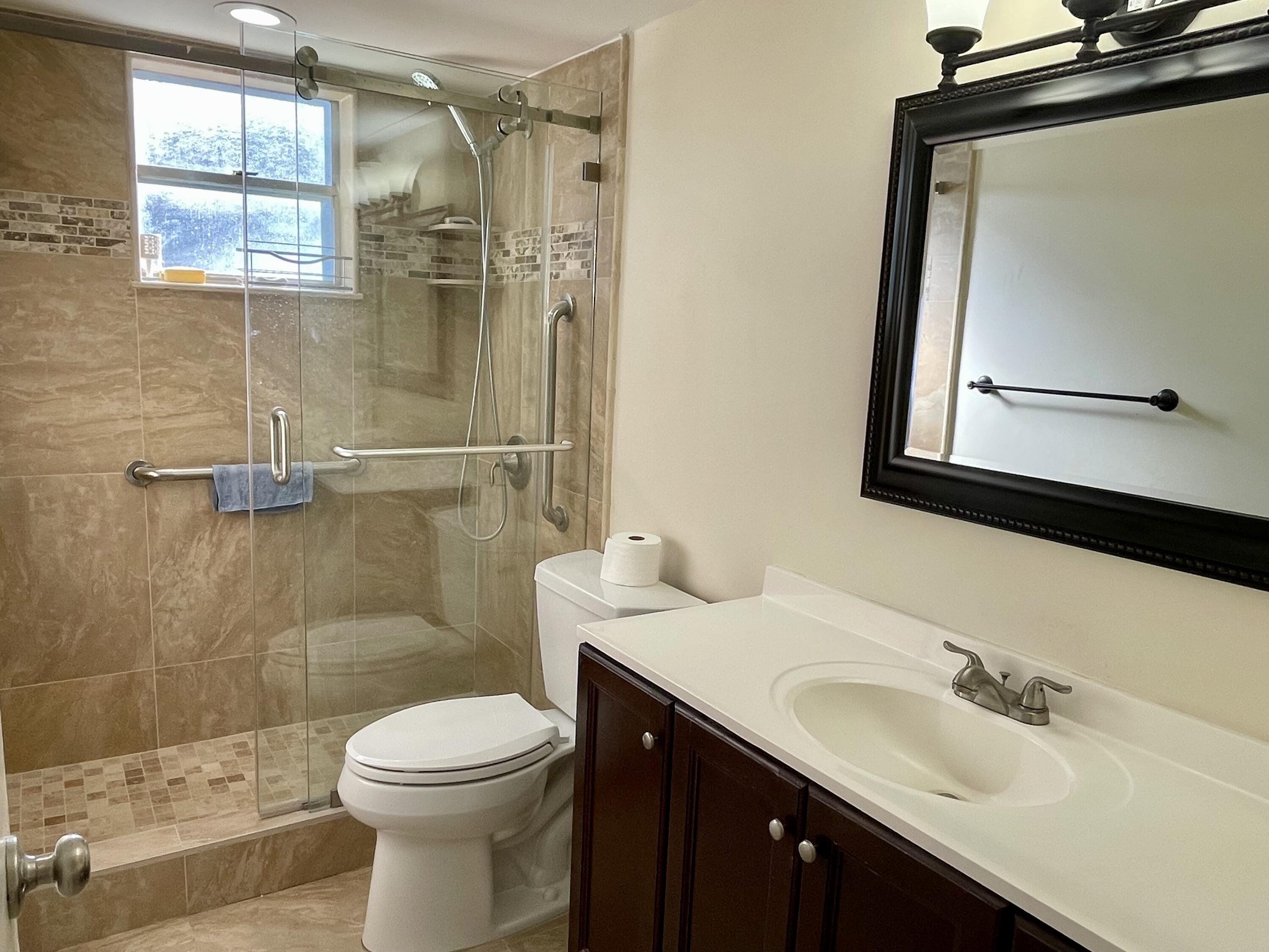 404 Fern Street, Unit 3A Jupiter, FL 33458 - Photo 9 of 12 a bathroom with a sink a toilet and shower