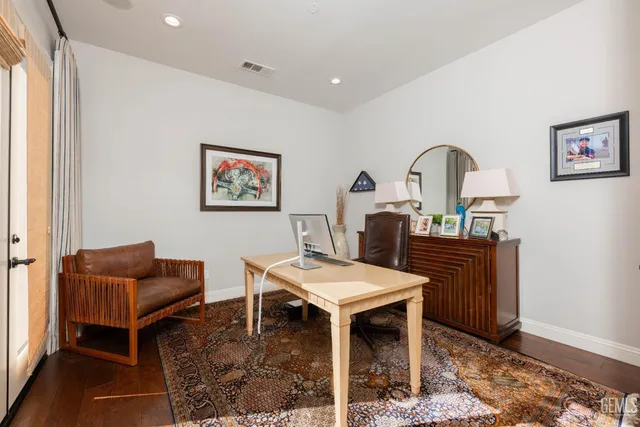 a bathroom with a granite countertop sink a toilet and a mirror