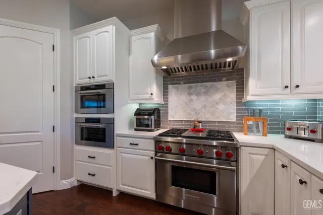 a spacious bathroom with a tub sink and mirror