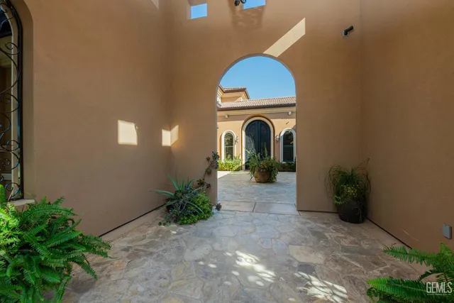 a living room with furniture a fireplace a flat screen tv and a potted plant