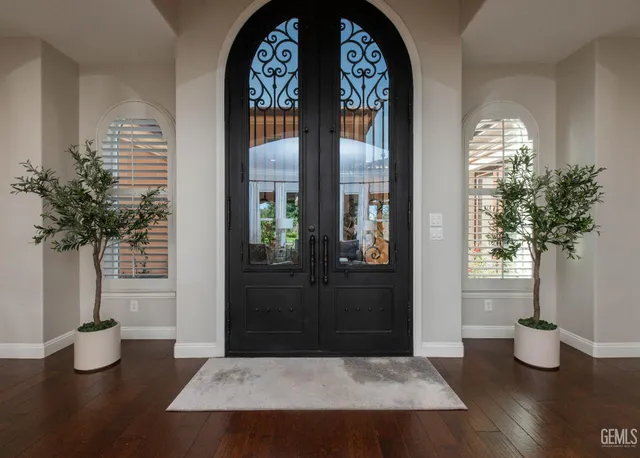 a living room with furniture a large window and a fireplace