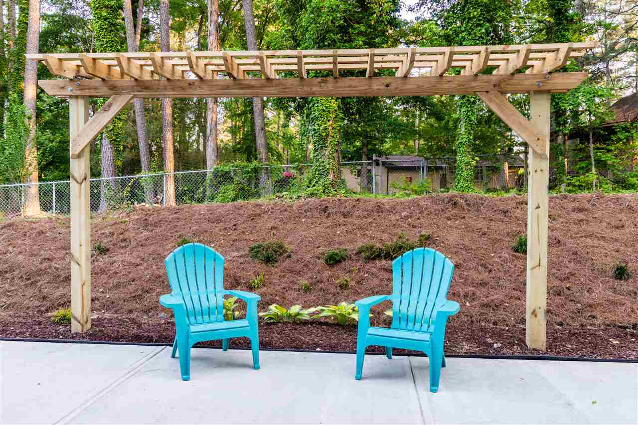 5317 B Fayetteville Road Durham, NC 27713 - Photo 27 of 30 Large concrete patio with arbor and nature view Large patio with arbor