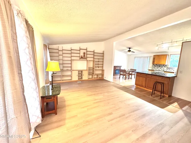 a spacious bedroom with a large window and a table