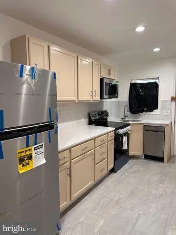 a kitchen with a sink a microwave and cabinets
