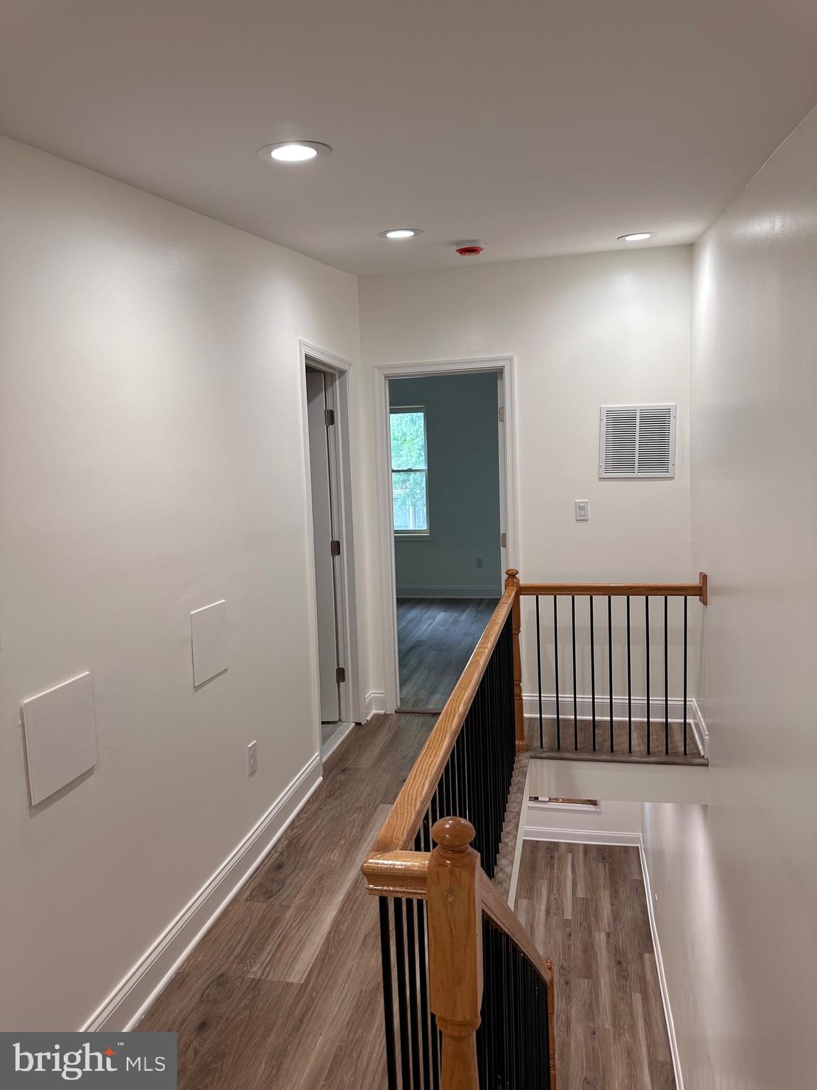 458 Federal Street Baltimore, MD 21202 - Photo 3 of 4 a view of a hallway with wooden floor and stairs