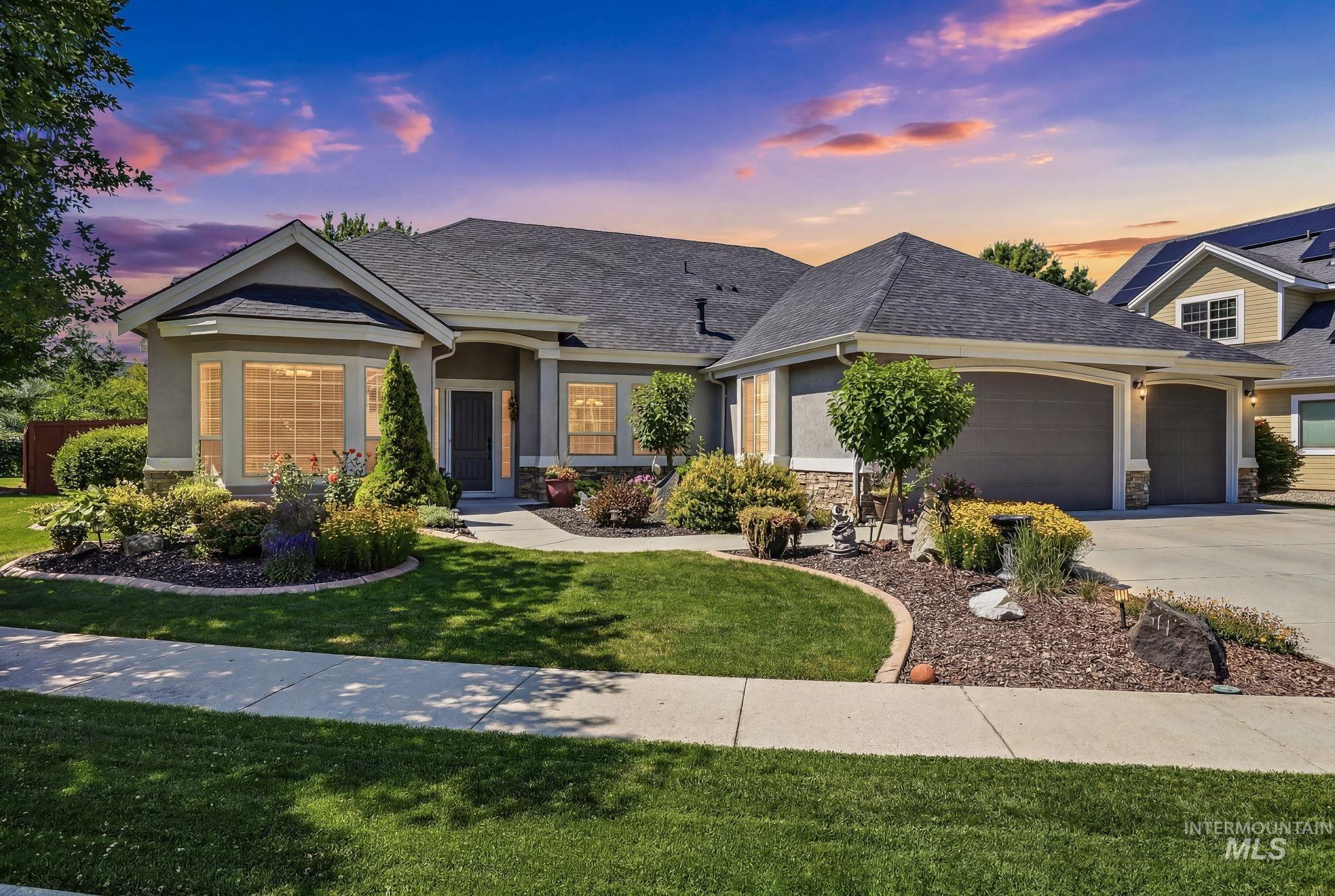3969 North Hollymount Way Meridian, ID 83646 - Photo 46 of 47 Stucco exterior featuring stone accents, a multi-pane bay window, and a dark asphalt shingle roof