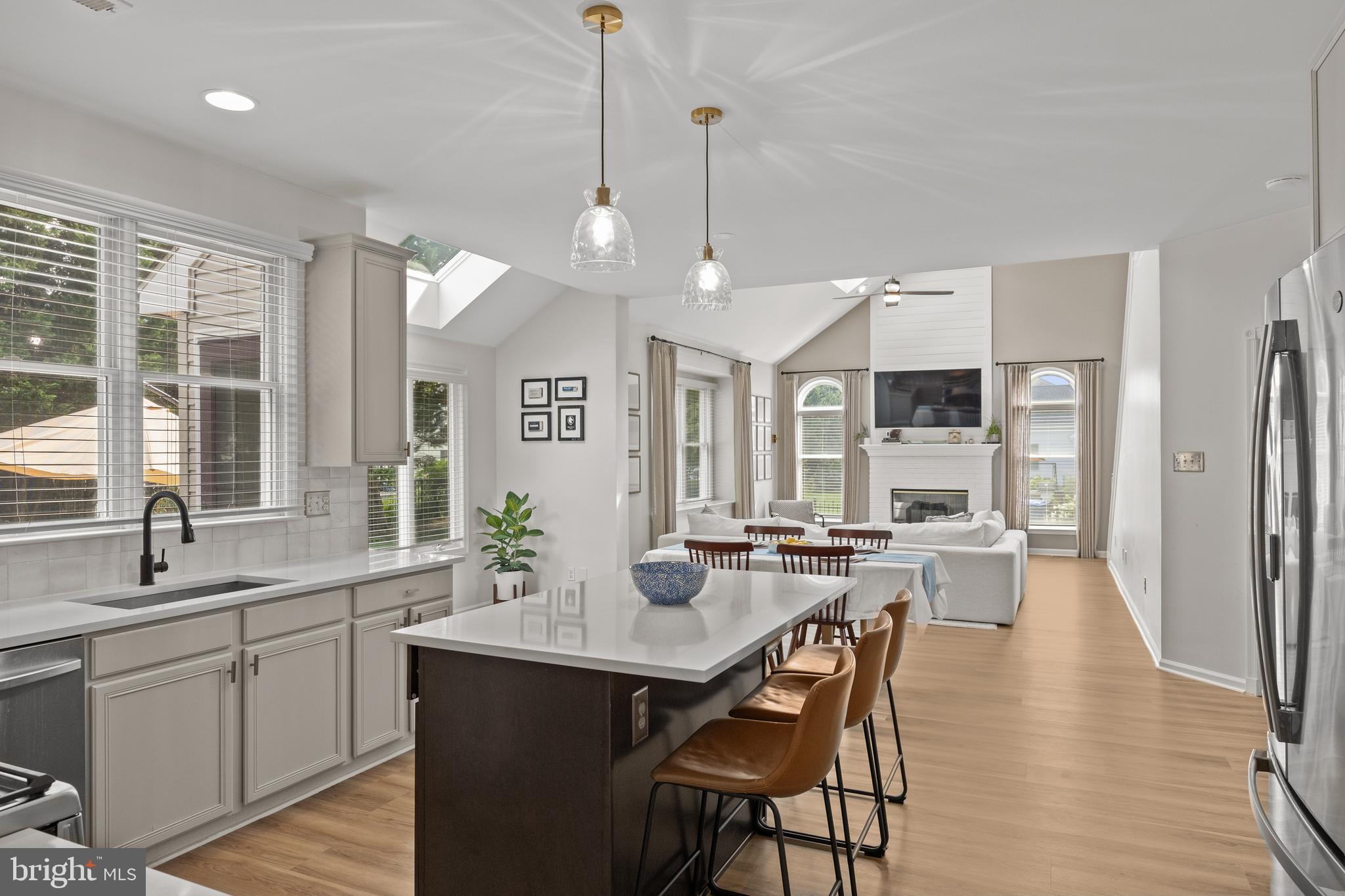 97 Brooks Road Moorestown, NJ 08057 - Photo 11 of 47 a kitchen with stainless steel appliances kitchen island granite countertop a stove a sink a dining table and chairs with wooden floor