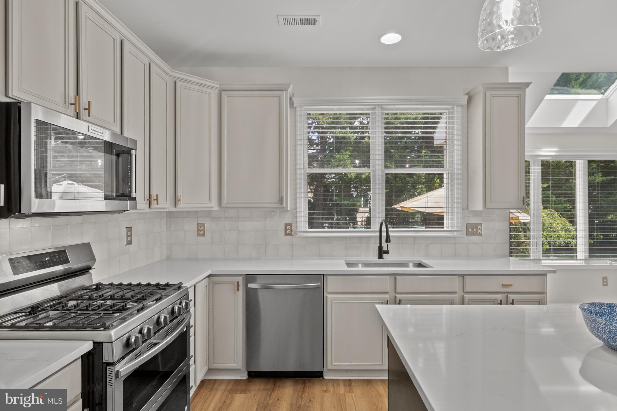 97 Brooks Road Moorestown, NJ 08057 - Photo 12 of 47 a kitchen with stainless steel appliances granite countertop a sink stove and cabinets