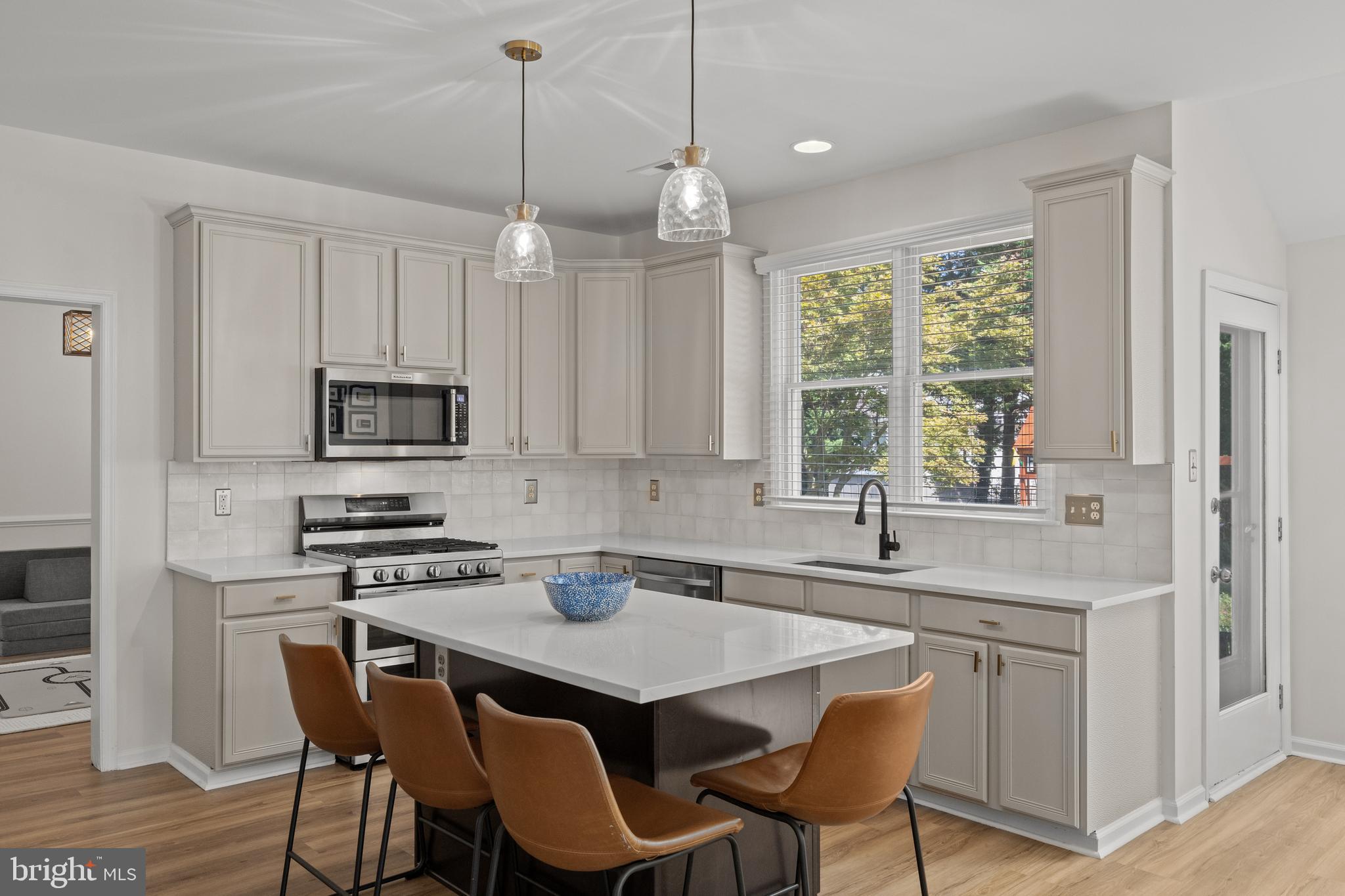 97 Brooks Road Moorestown, NJ 08057 - Photo 13 of 47 a kitchen with stainless steel appliances granite countertop a sink a stove a microwave a dining table and chairs
