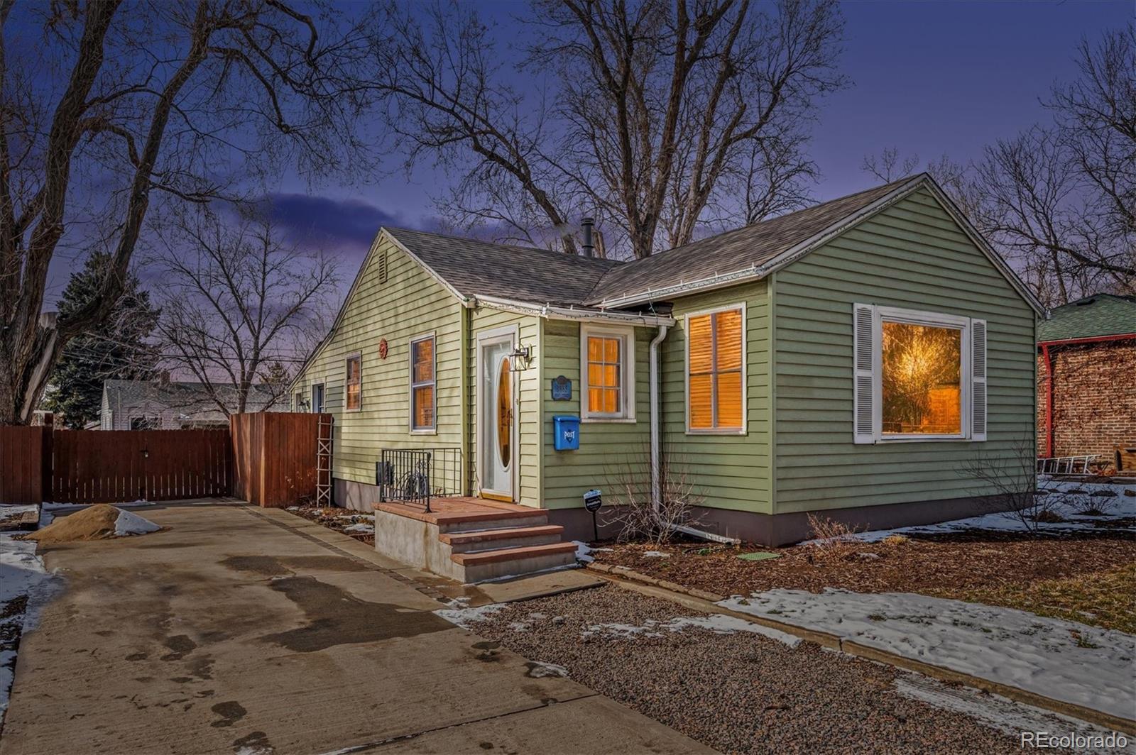 3885 Quay Street Wheat Ridge, CO 80033 - Photo 1 of 40 a front view of a house with garden