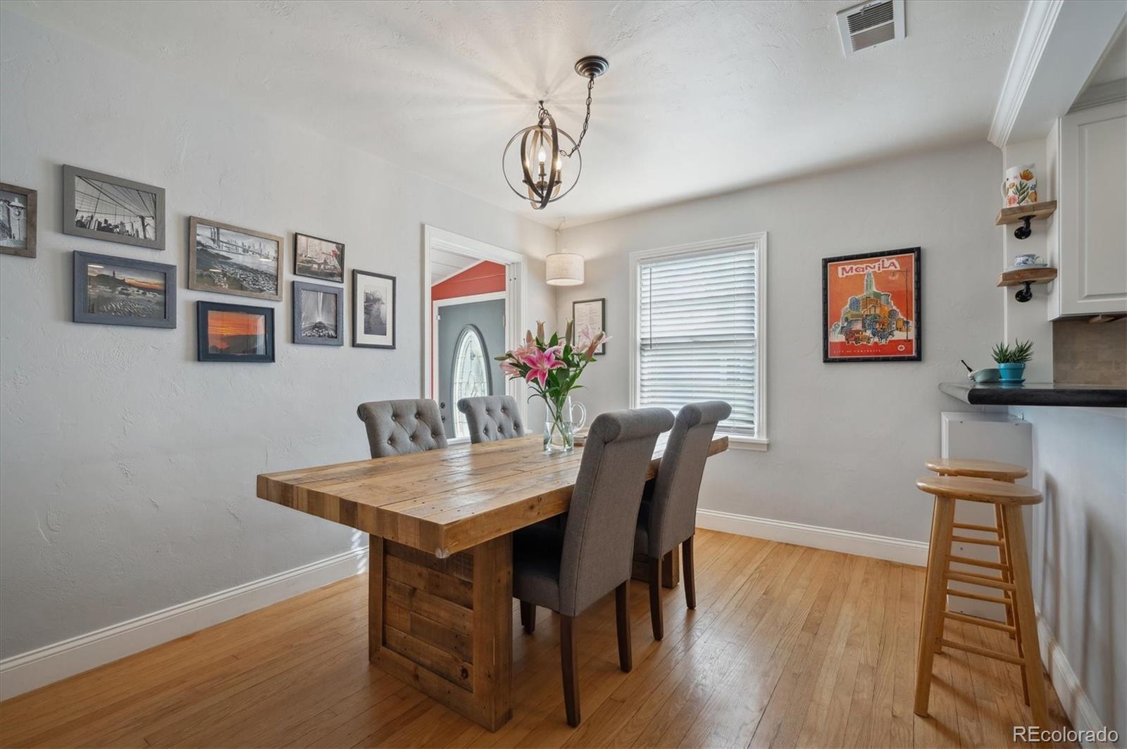 3885 Quay Street Wheat Ridge, CO 80033 - Photo 12 of 40 a view of a dining room with furniture and wooden floor