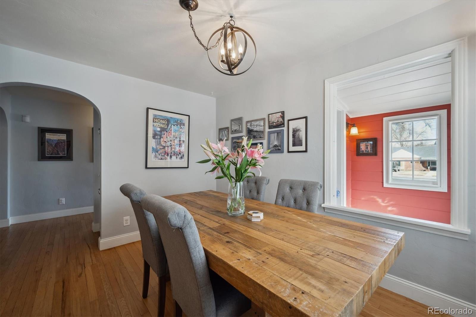 3885 Quay Street Wheat Ridge, CO 80033 - Photo 15 of 40 a dining room with wooden floor a chandelier a wooden table and chairs