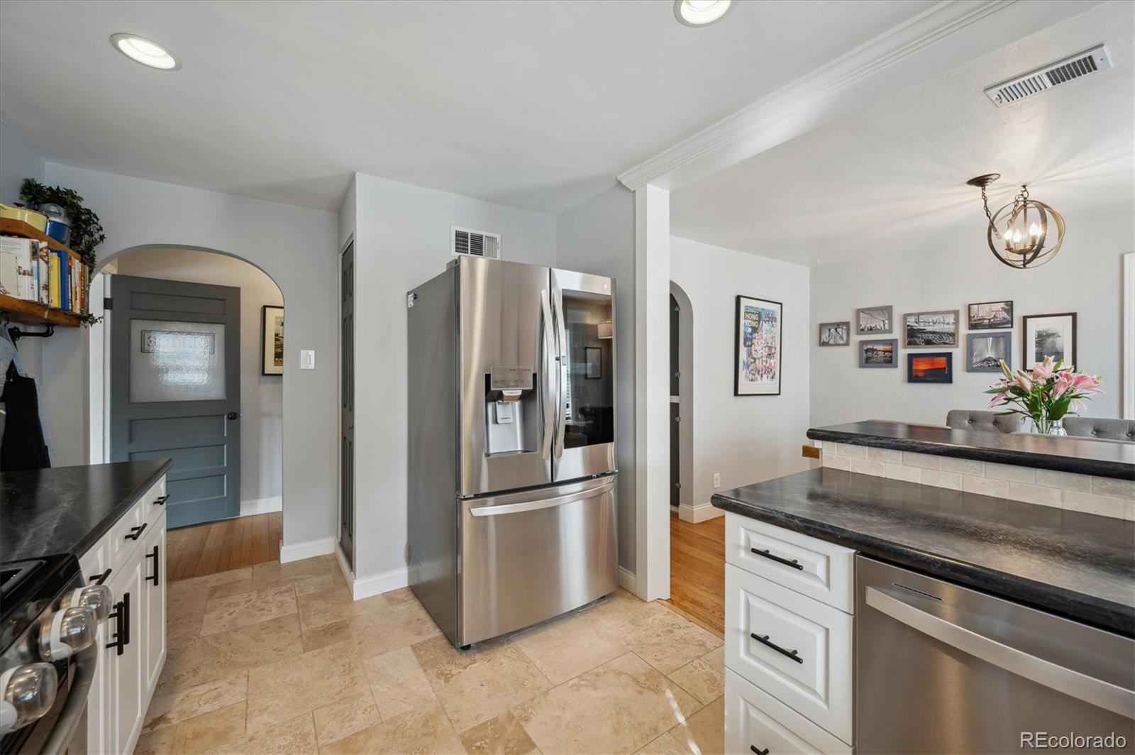 3885 Quay Street Wheat Ridge, CO 80033 - Photo 19 of 40 a kitchen with granite countertop a refrigerator and a sink