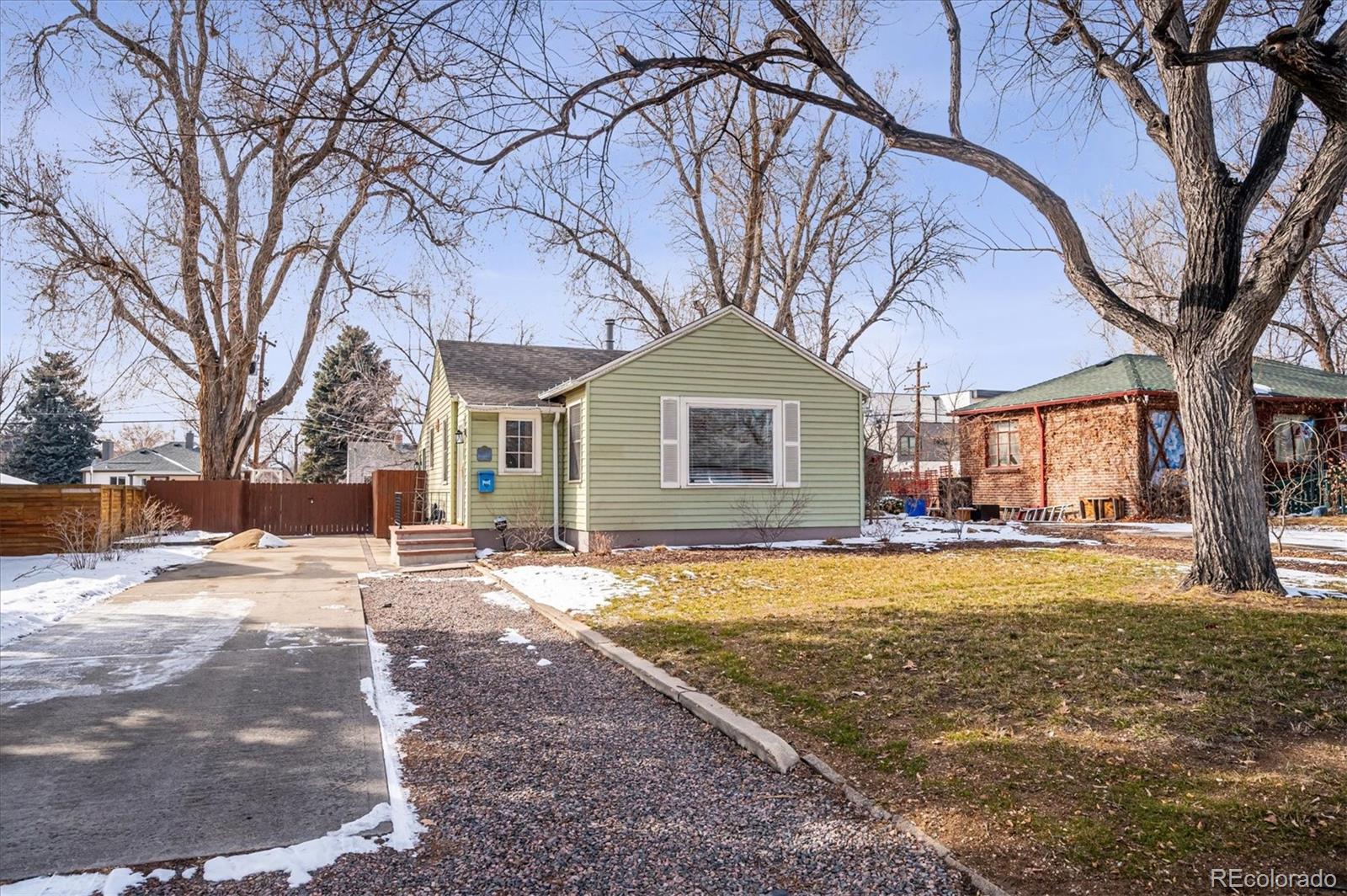 3885 Quay Street Wheat Ridge, CO 80033 - Photo 2 of 40 a view of a yard with a house and large trees