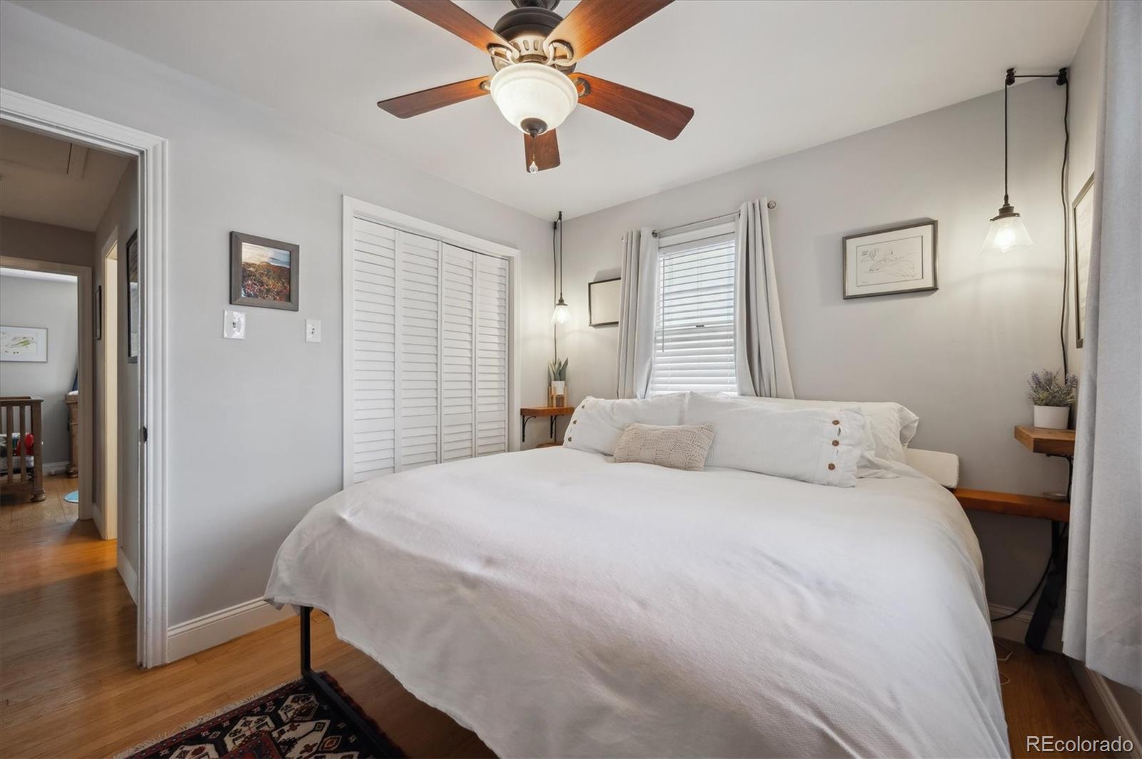 3885 Quay Street Wheat Ridge, CO 80033 - Photo 21 of 40 a bedroom with a bed and a chandelier