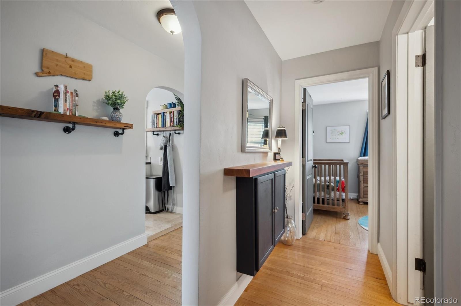 3885 Quay Street Wheat Ridge, CO 80033 - Photo 22 of 40 a view of a hallway with a livingroom and furniture