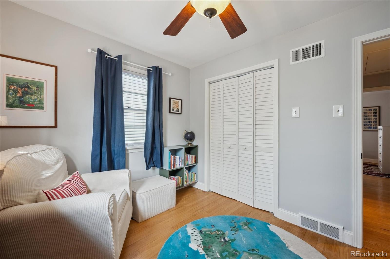 3885 Quay Street Wheat Ridge, CO 80033 - Photo 25 of 40 a bedroom with a bed and wooden floor