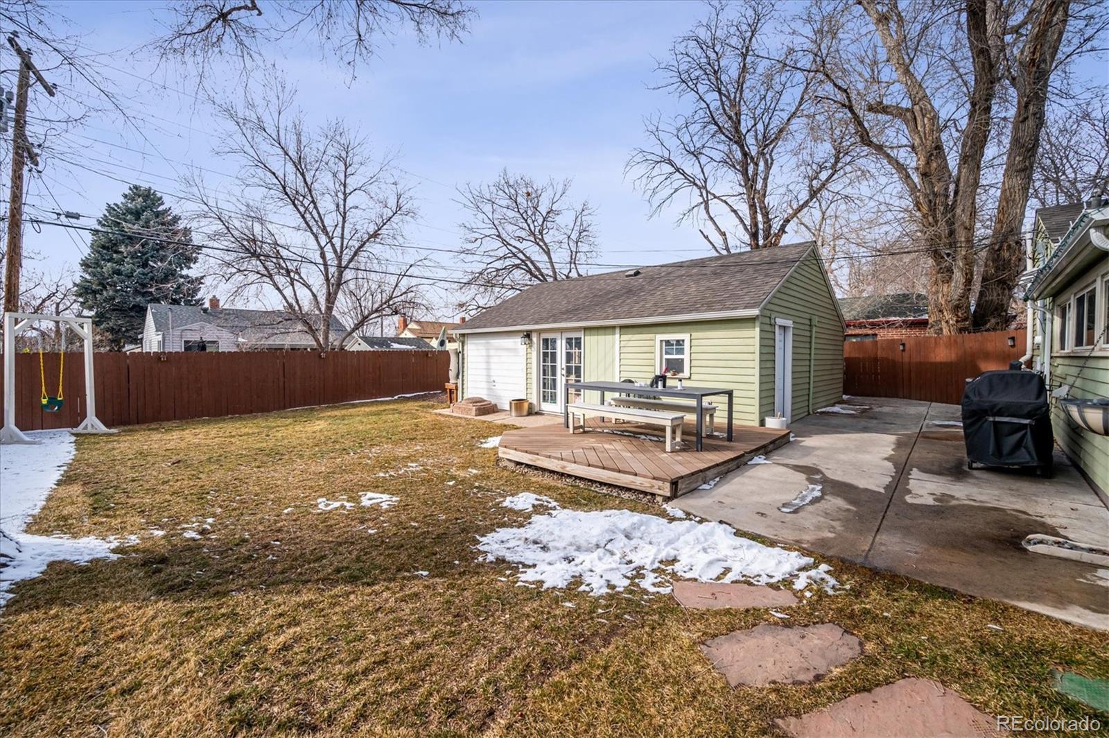 3885 Quay Street Wheat Ridge, CO 80033 - Photo 31 of 40 a view of a house with a yard covered in snow