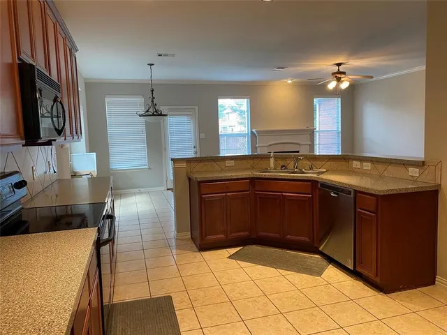 a kitchen with a sink and a stove top oven