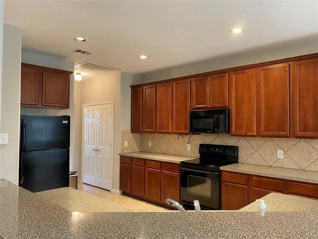 a kitchen with a refrigerator stove and microwave