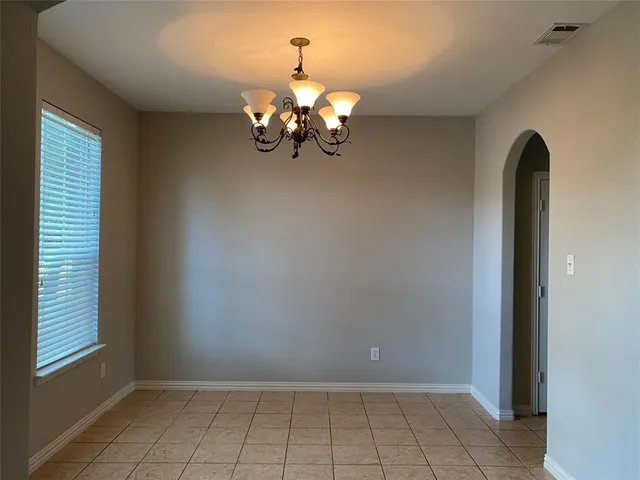 a view of a chandelier fan and fire place