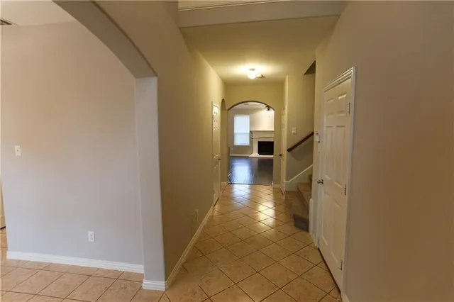 a view of a hallway view with wooden floor and staircase