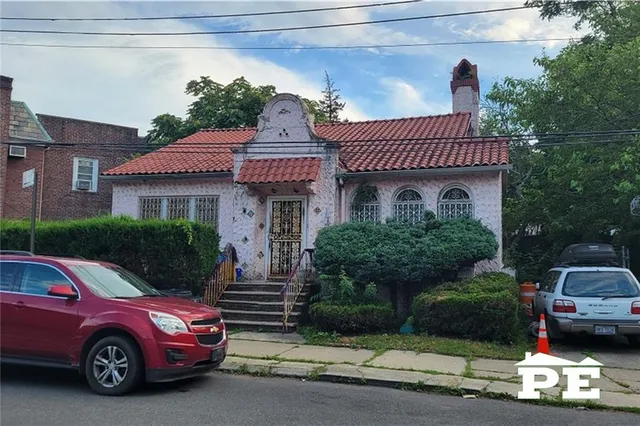 a front view of a house with a garden
