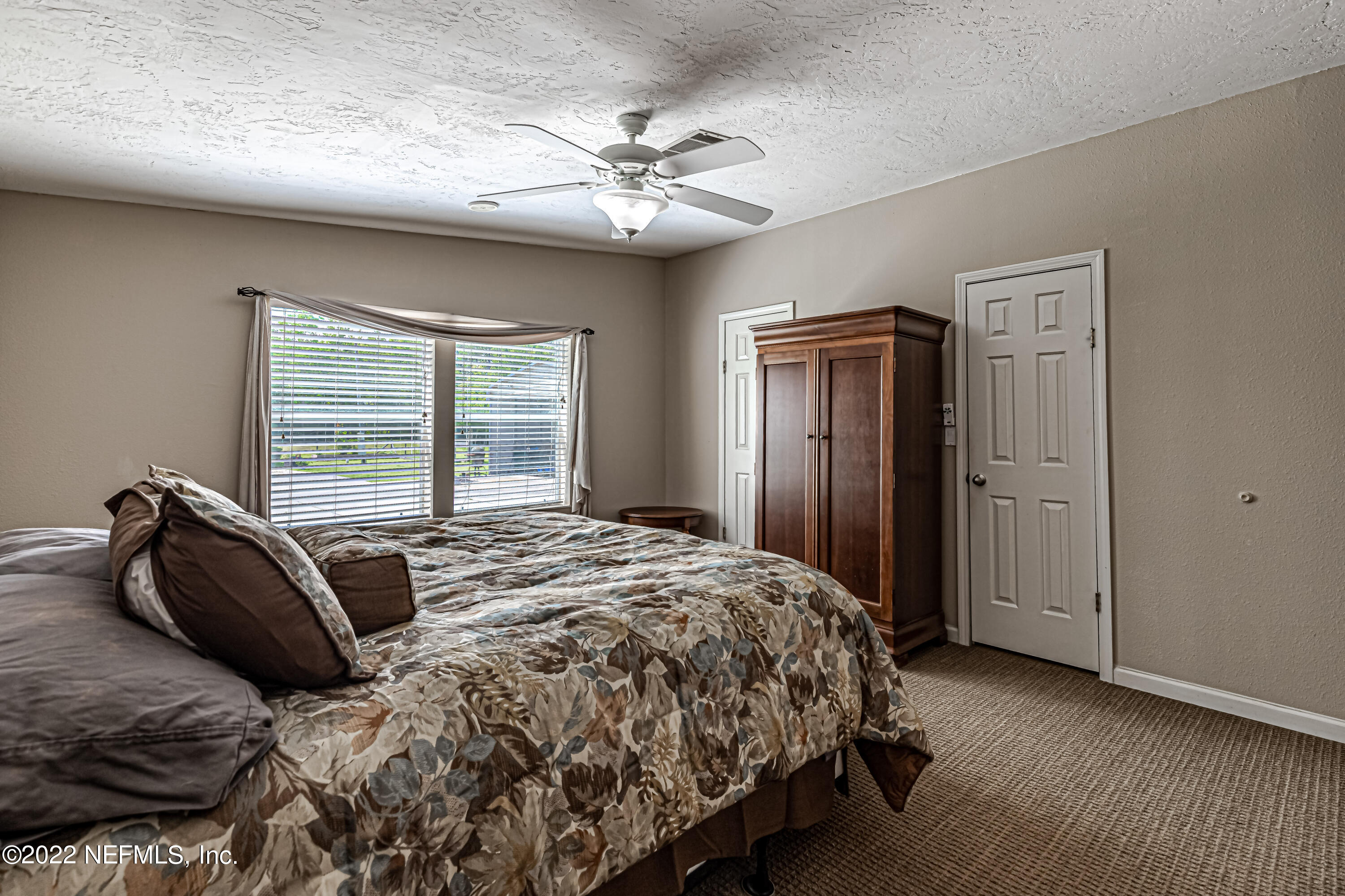 1376 Marlee Road, Unit 1 St. Johns, FL 32259 - Photo 25 of 50 a bedroom with a bed and a large mirror