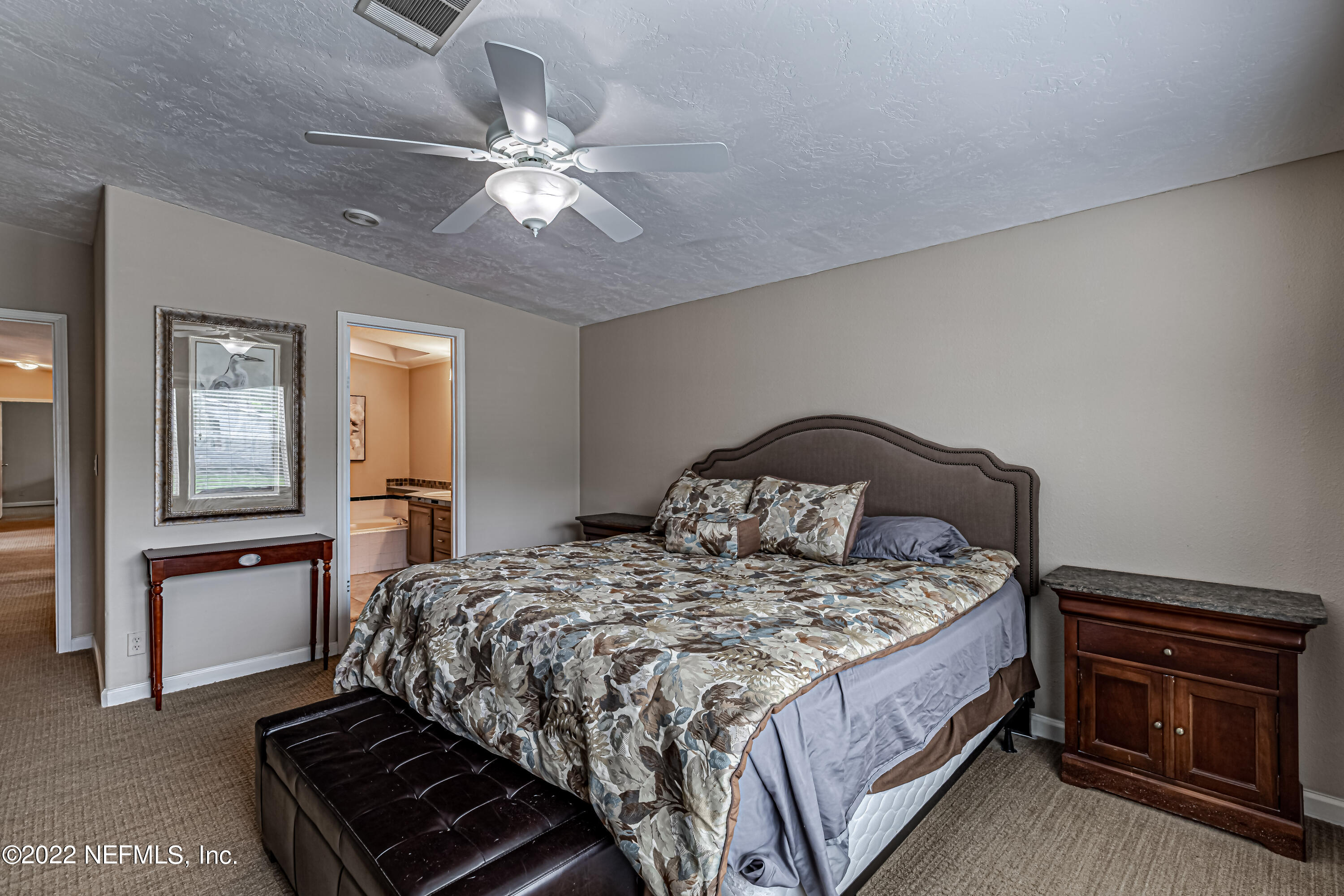 1376 Marlee Road, Unit 1 St. Johns, FL 32259 - Photo 26 of 50 a bedroom with a bed and a chandelier