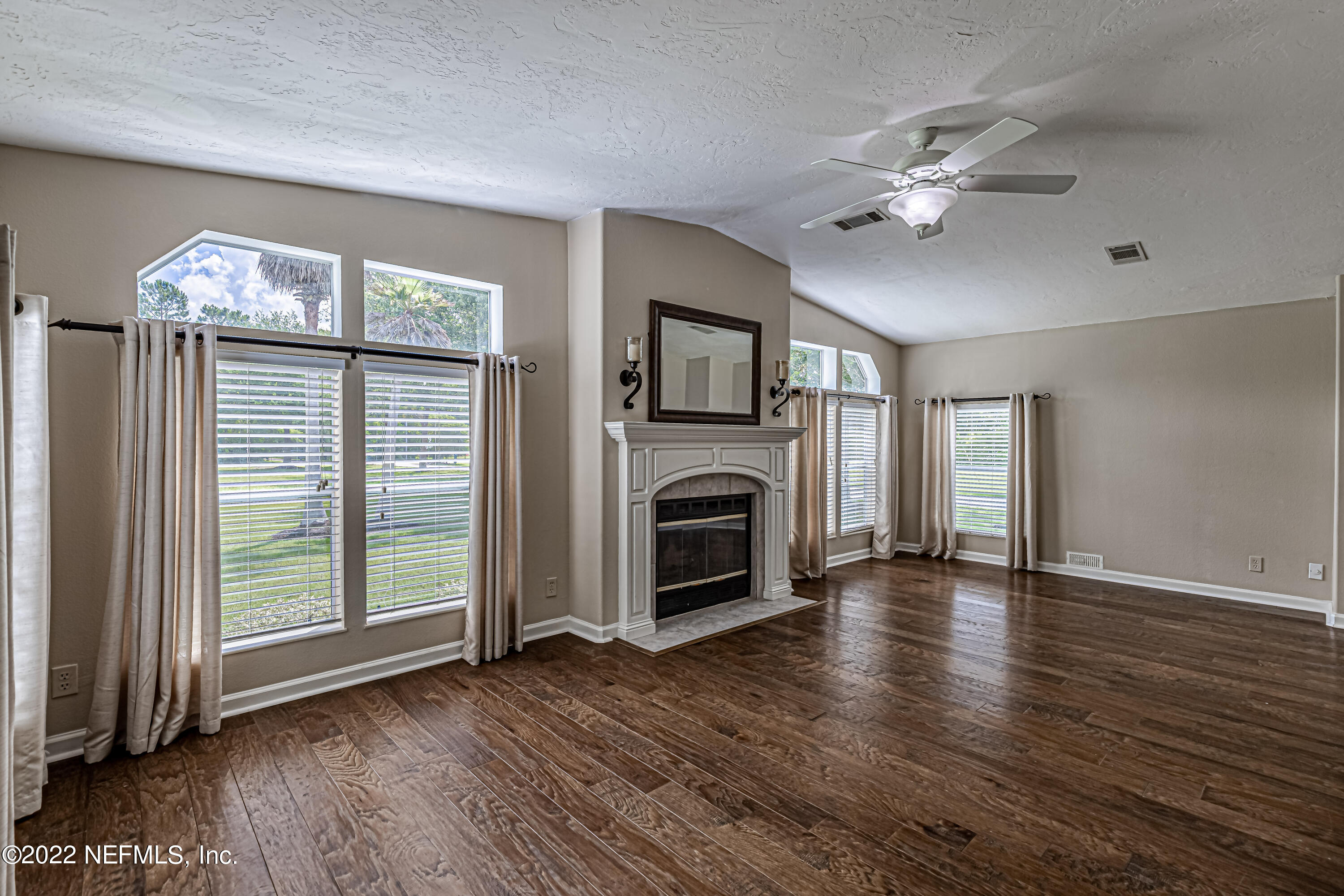1376 Marlee Road, Unit 1 St. Johns, FL 32259 - Photo 7 of 50 a view of a livingroom with a fireplace wooden floor and windows