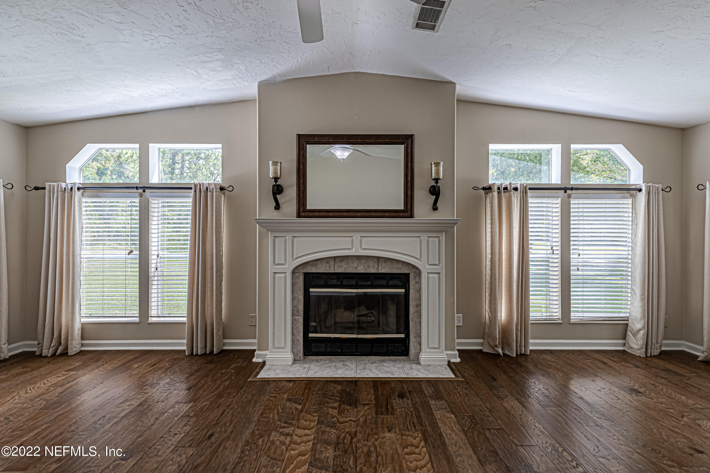 1376 Marlee Road, Unit 1 St. Johns, FL 32259 - Photo 9 of 50 an empty room with wooden floor fireplace and windows