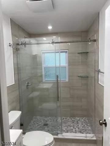 a bathroom with a shower and toilet