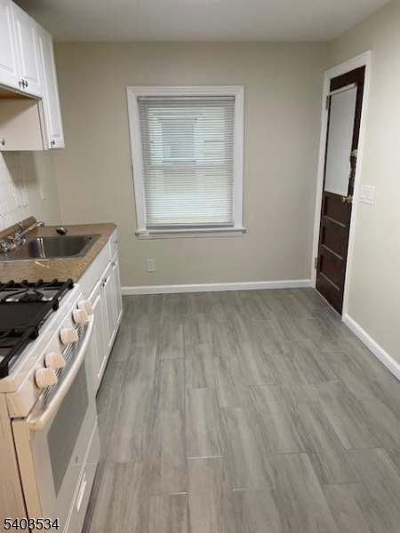 19 Rosedale Avenue Montclair, NJ 07042 - Photo 8 of 9 an entryway with wooden floor and cabinets