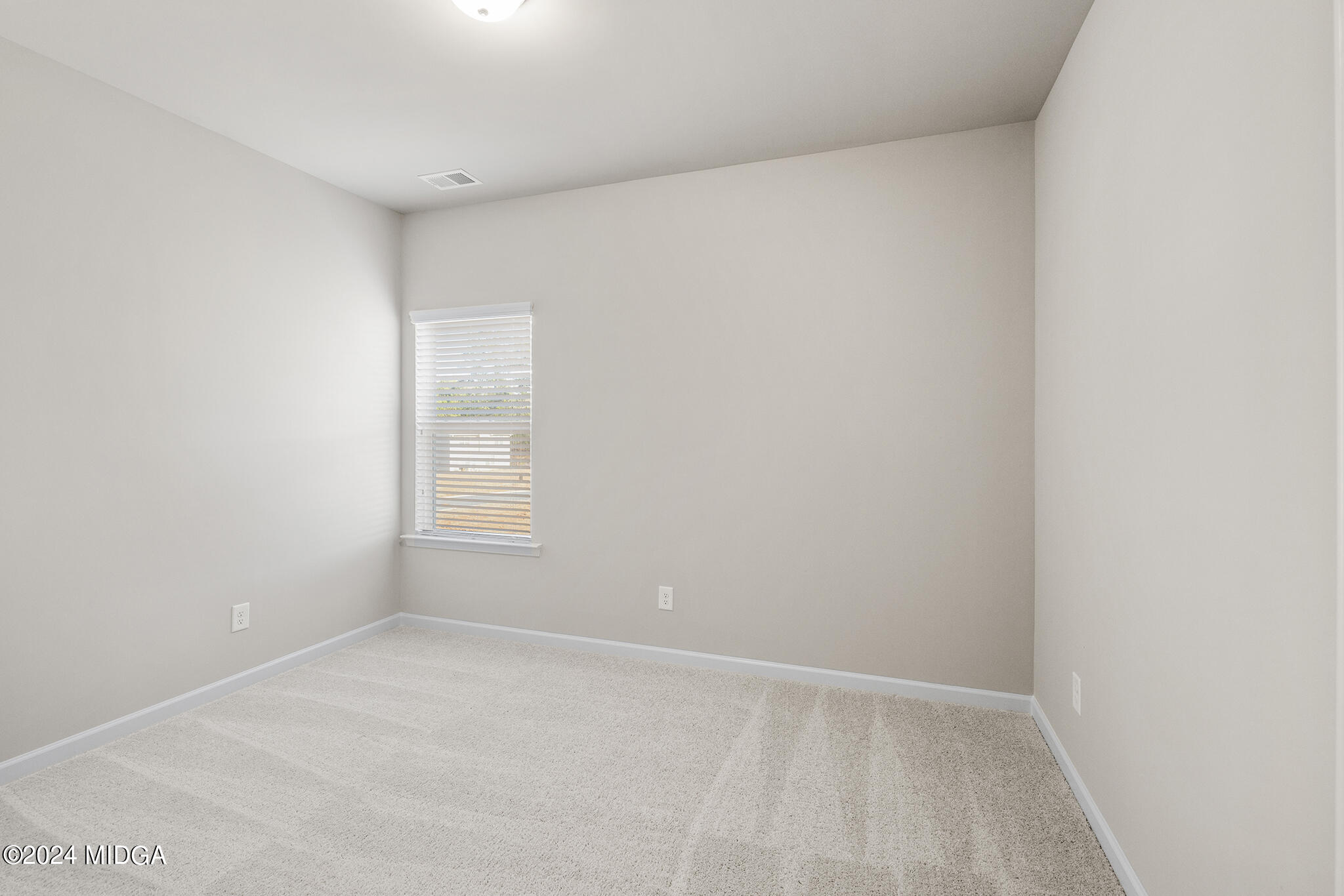 499 Grand Magnolia Street Jackson, GA 30233 - Photo 17 of 35 a view of an empty room and window